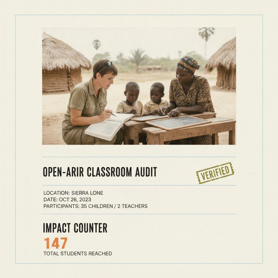 A verification visitor crouches beside children at low desks in an open-air classroom, comparing notes with a local teacher